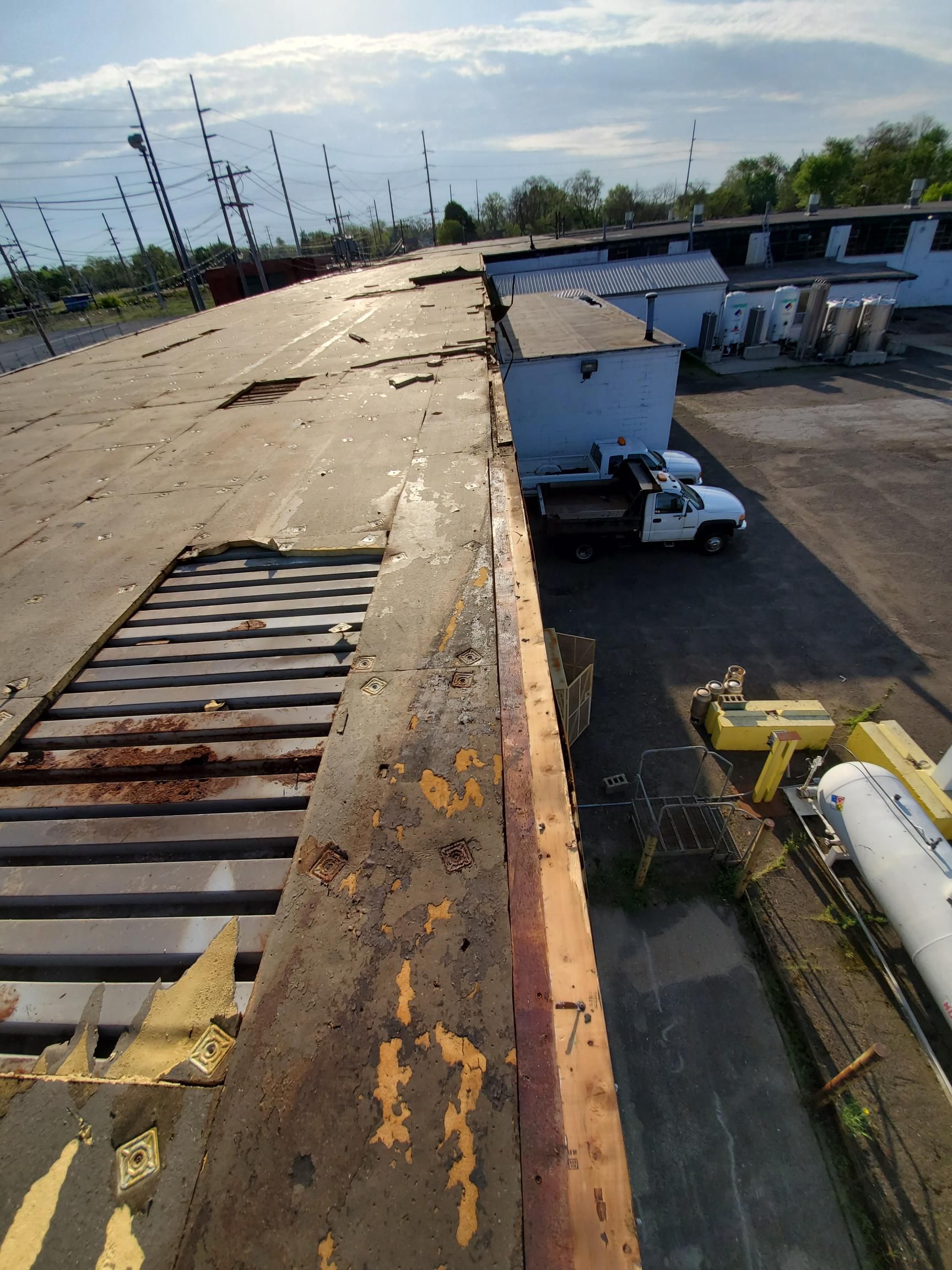 A truck is parked in a parking lot next to a building.