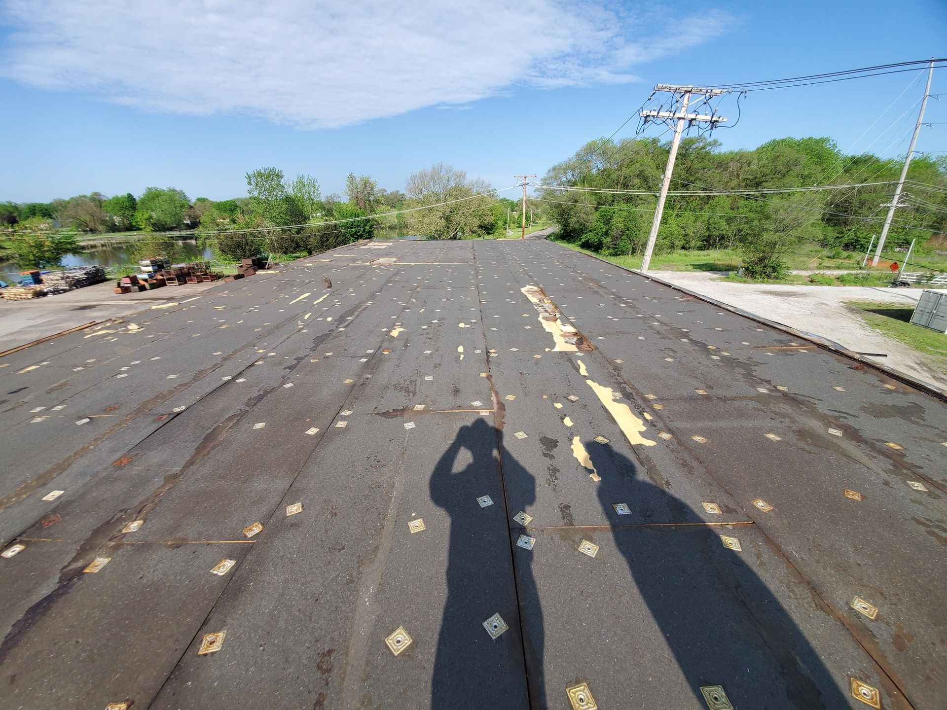 A shadow of a person is cast on the roof of a building
