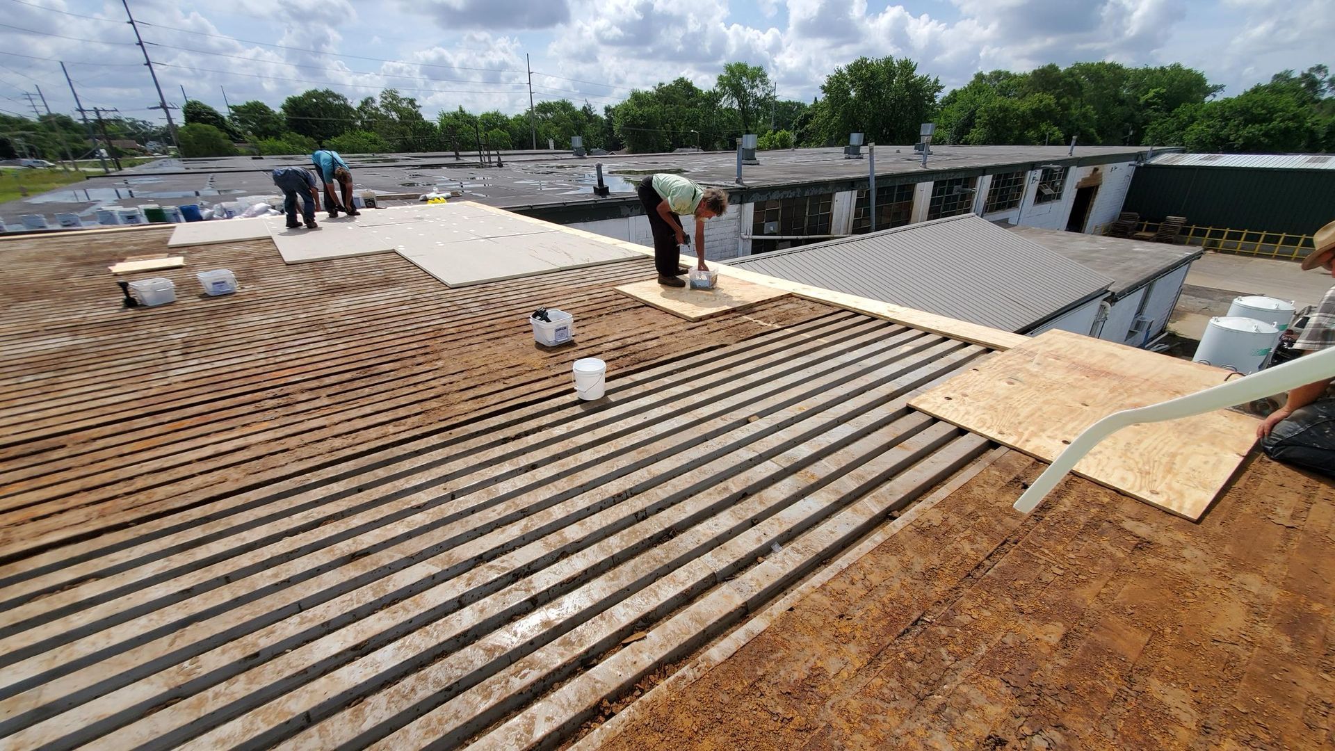 A group of people are working on the roof of a building.