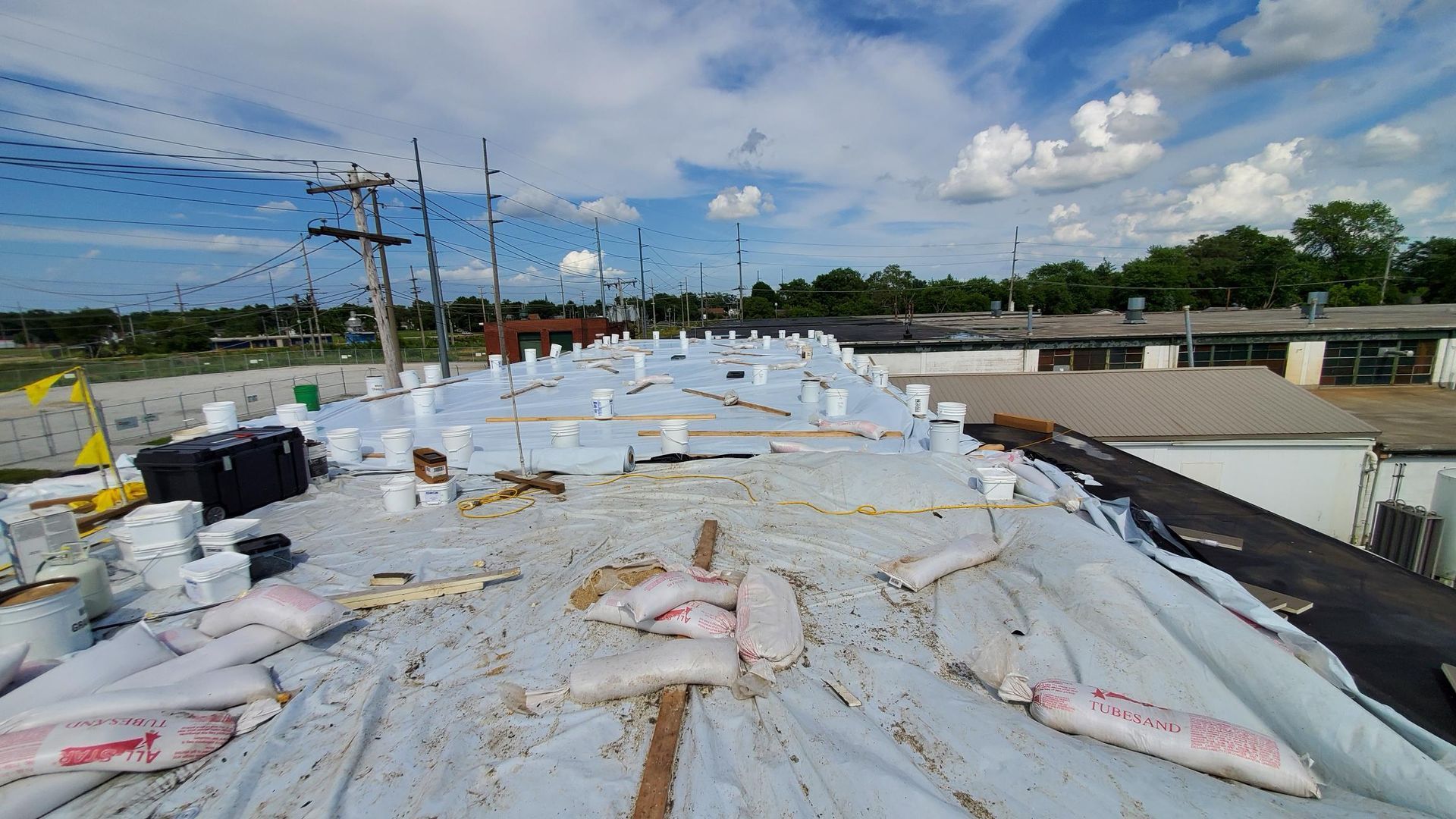 The roof of a building is covered in plastic.