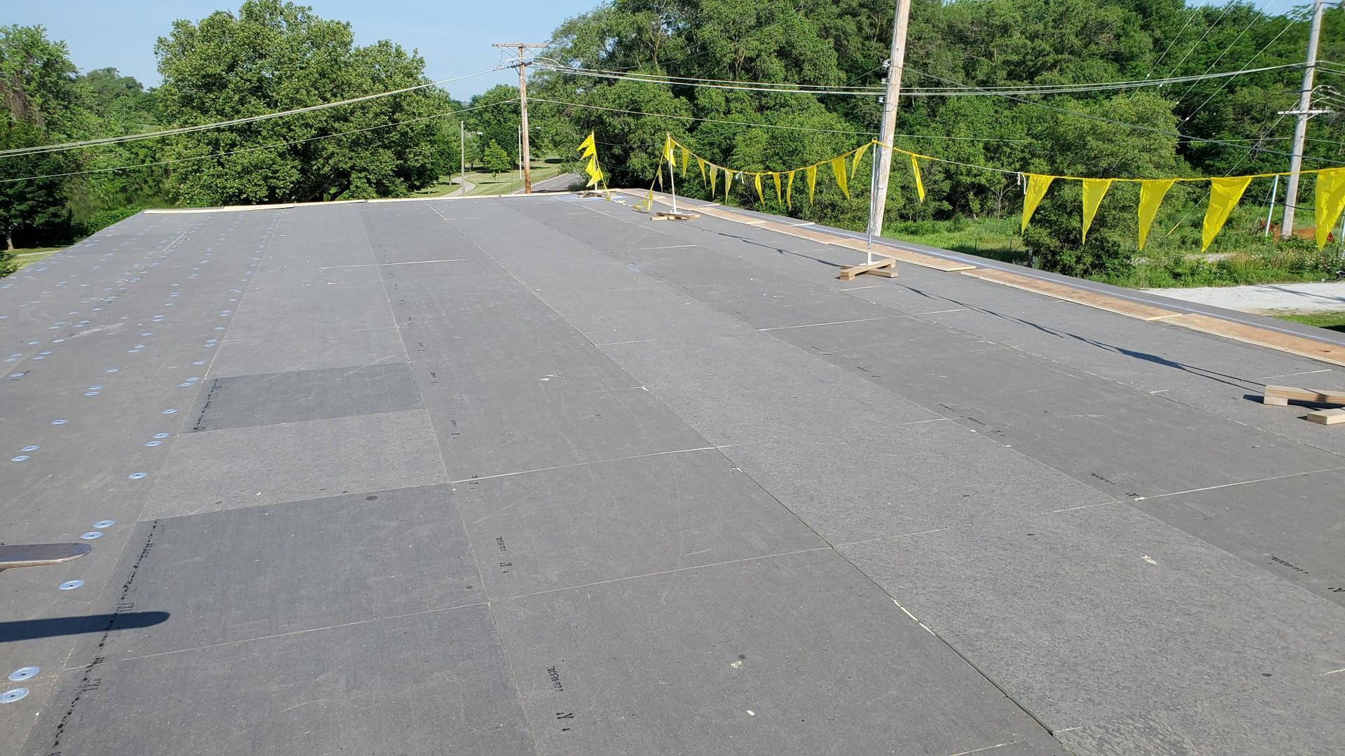 A roof with a lot of yellow flags on it