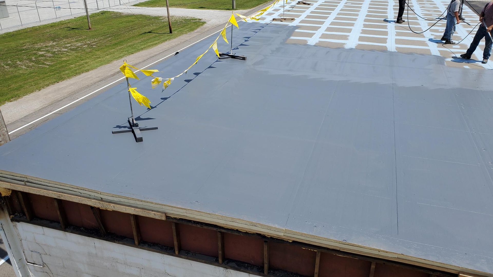 A group of people are standing on top of a concrete floor.