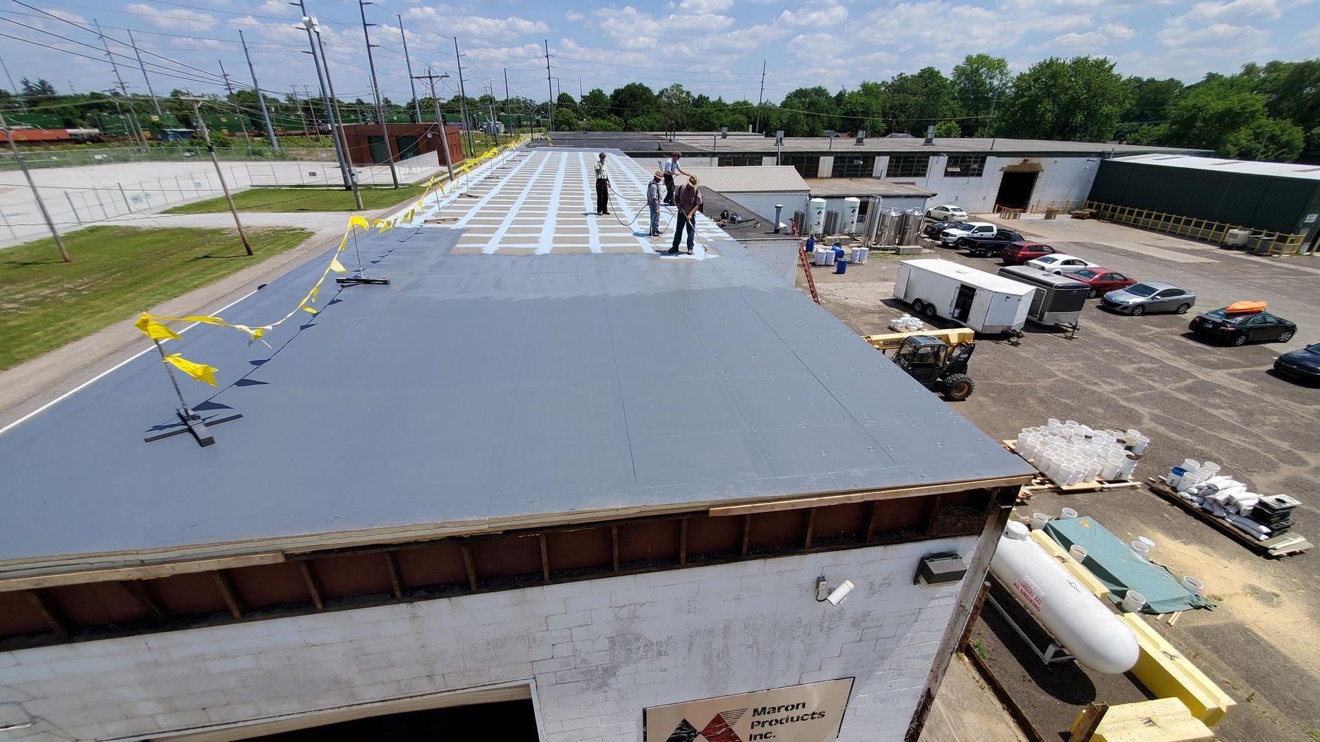 A group of people are working on the roof of a building.