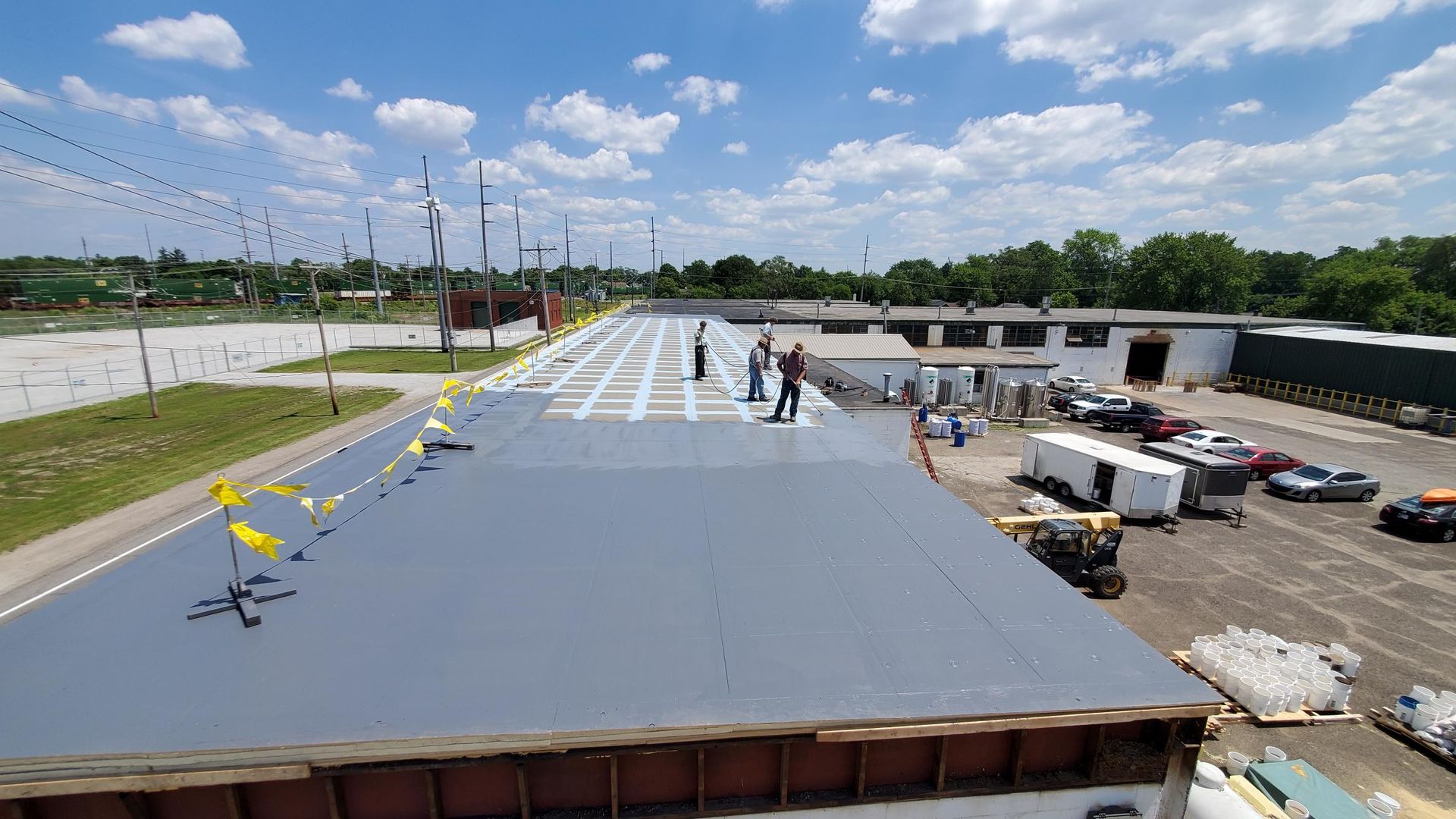 A group of people are working on the roof of a building.