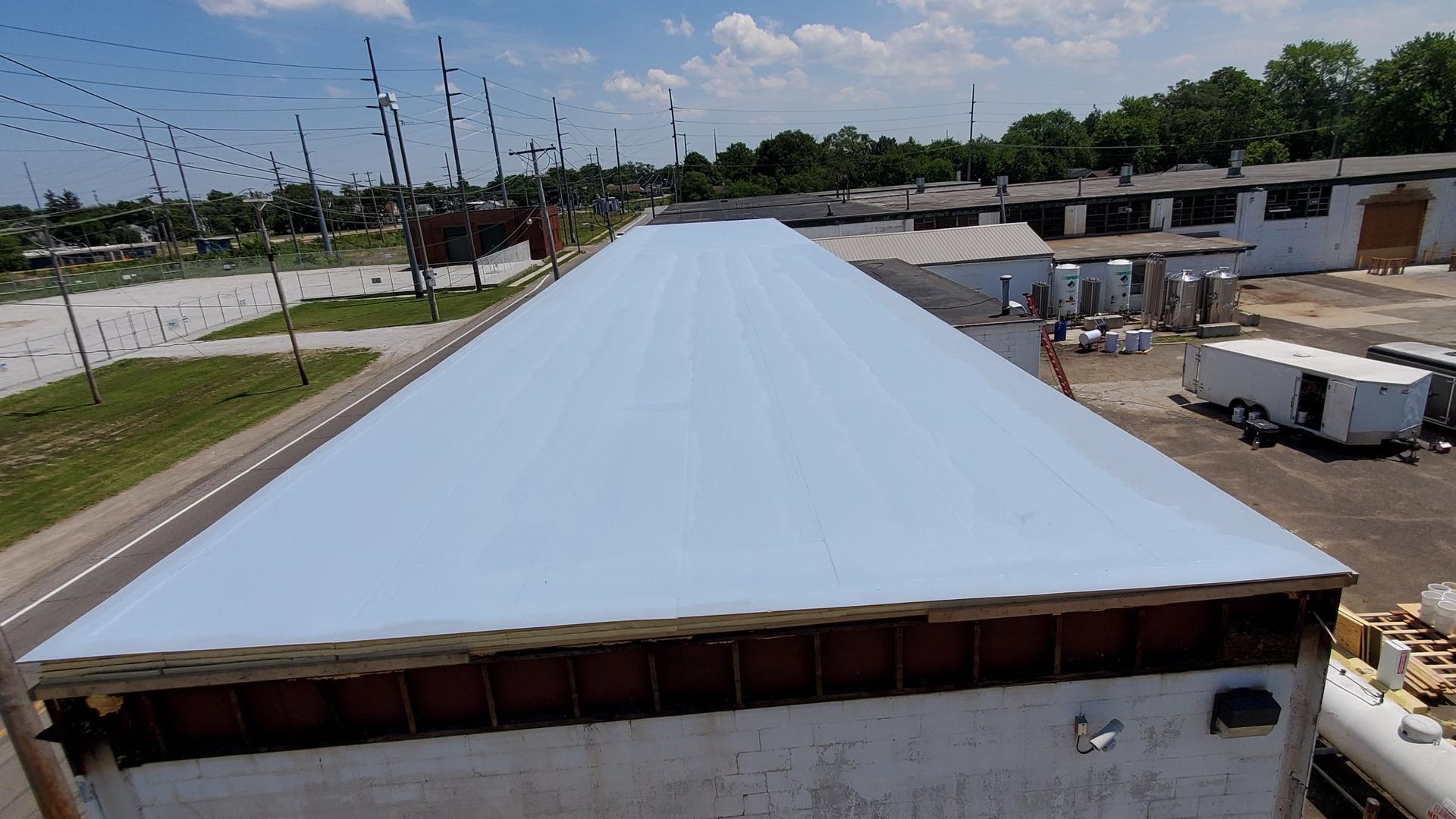 A large white roof is being installed on a building.
