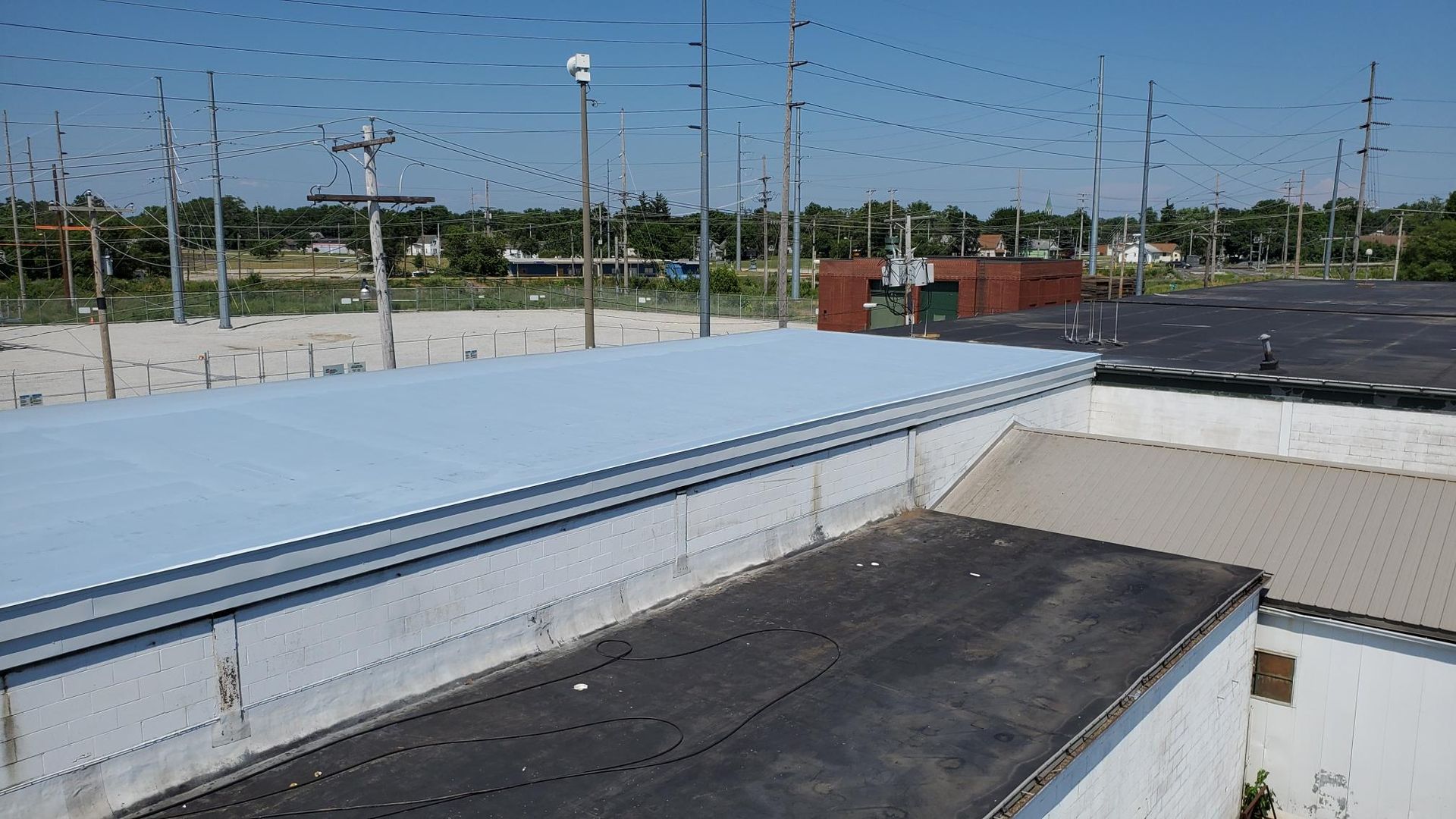 A roof of a building with a blue roof and a black roof.