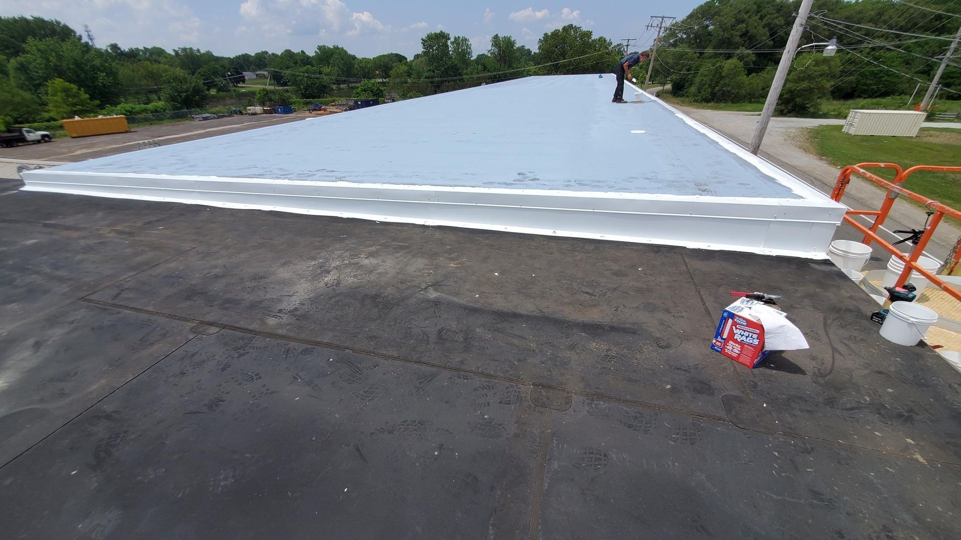 A large roof with a lot of white tape on it.