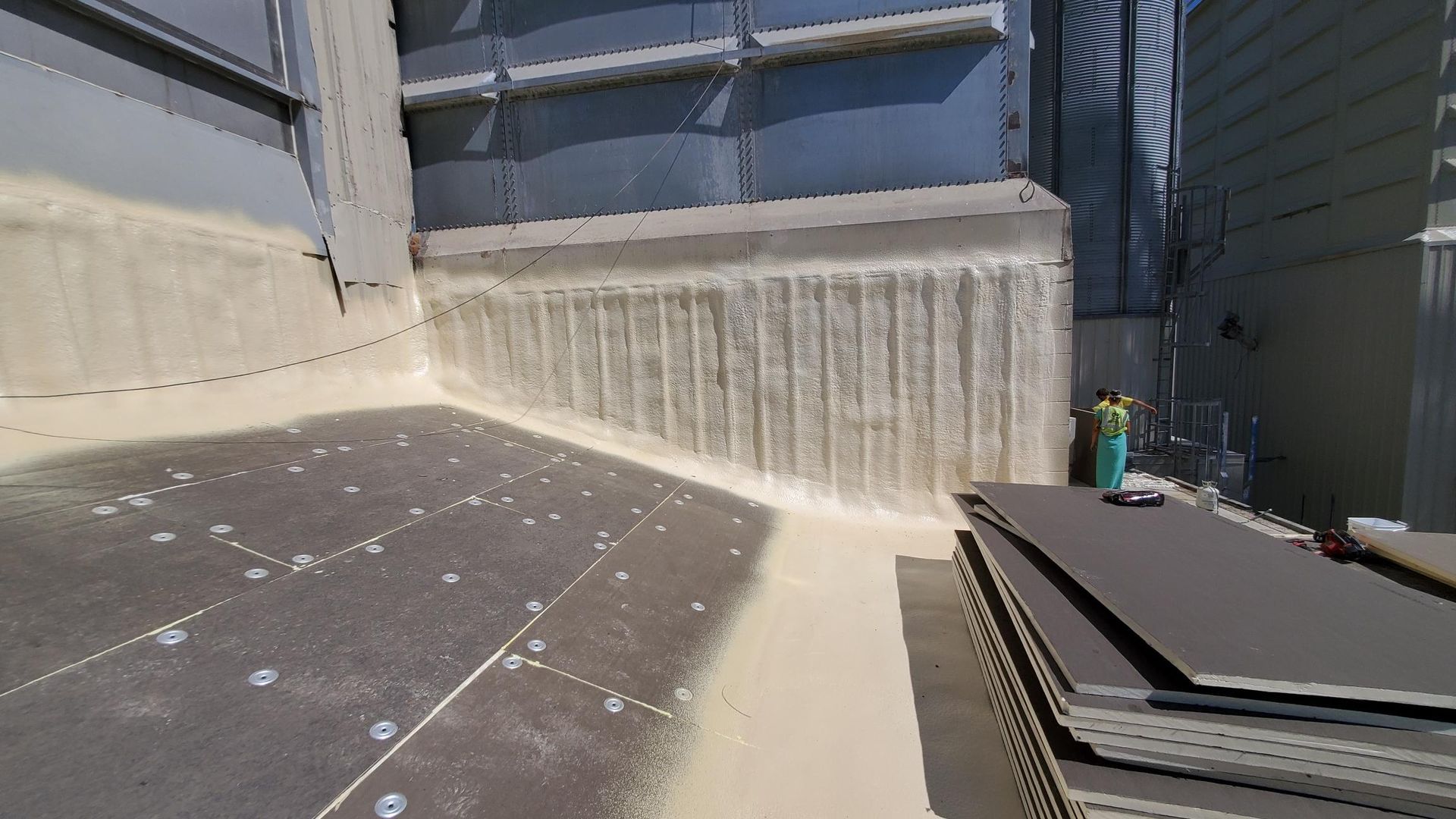 A stack of cardboard boxes sitting on top of a concrete floor.