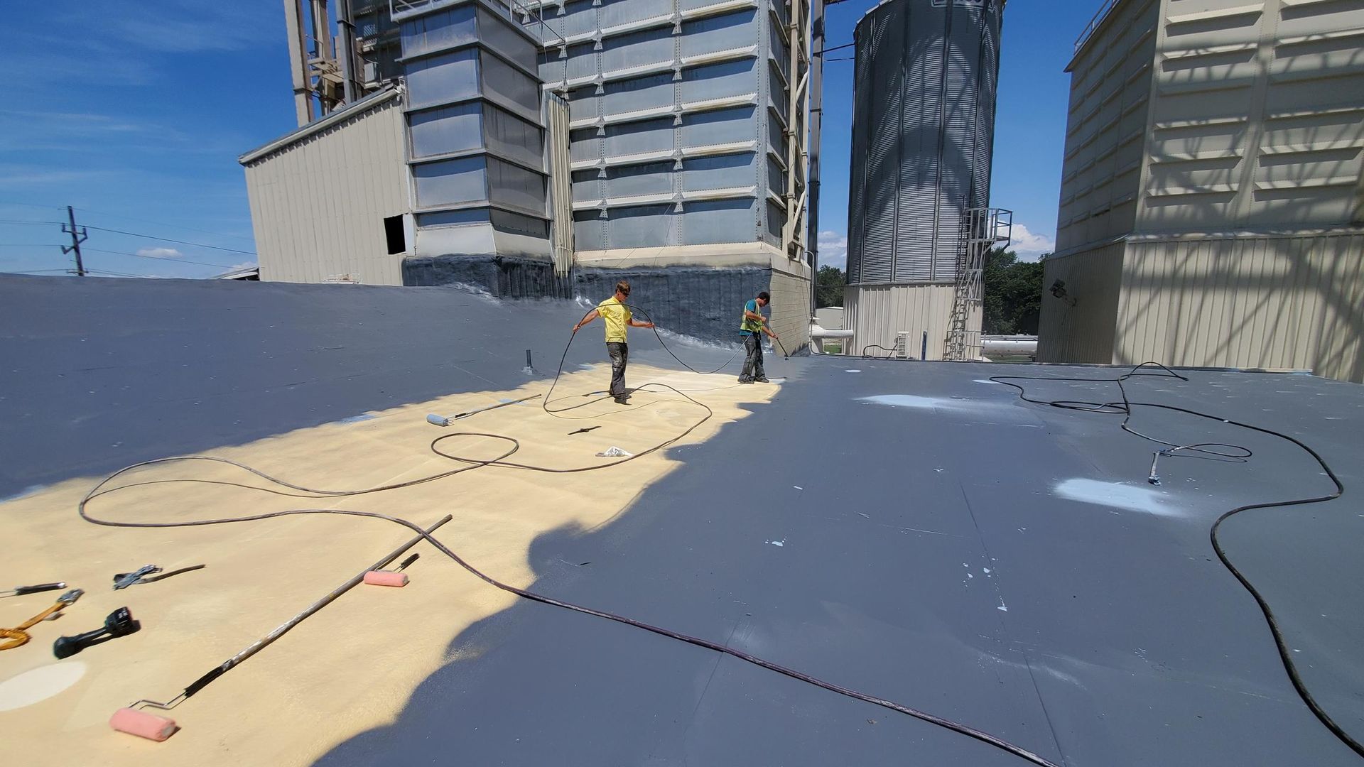 A group of people are standing on top of a roof.