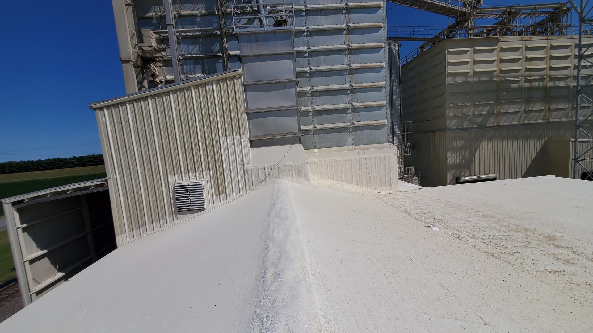 A large building with a lot of white powder on the roof.