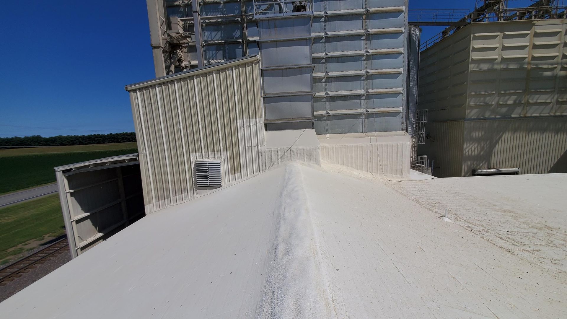 A large pile of white sand is sitting on top of a building.