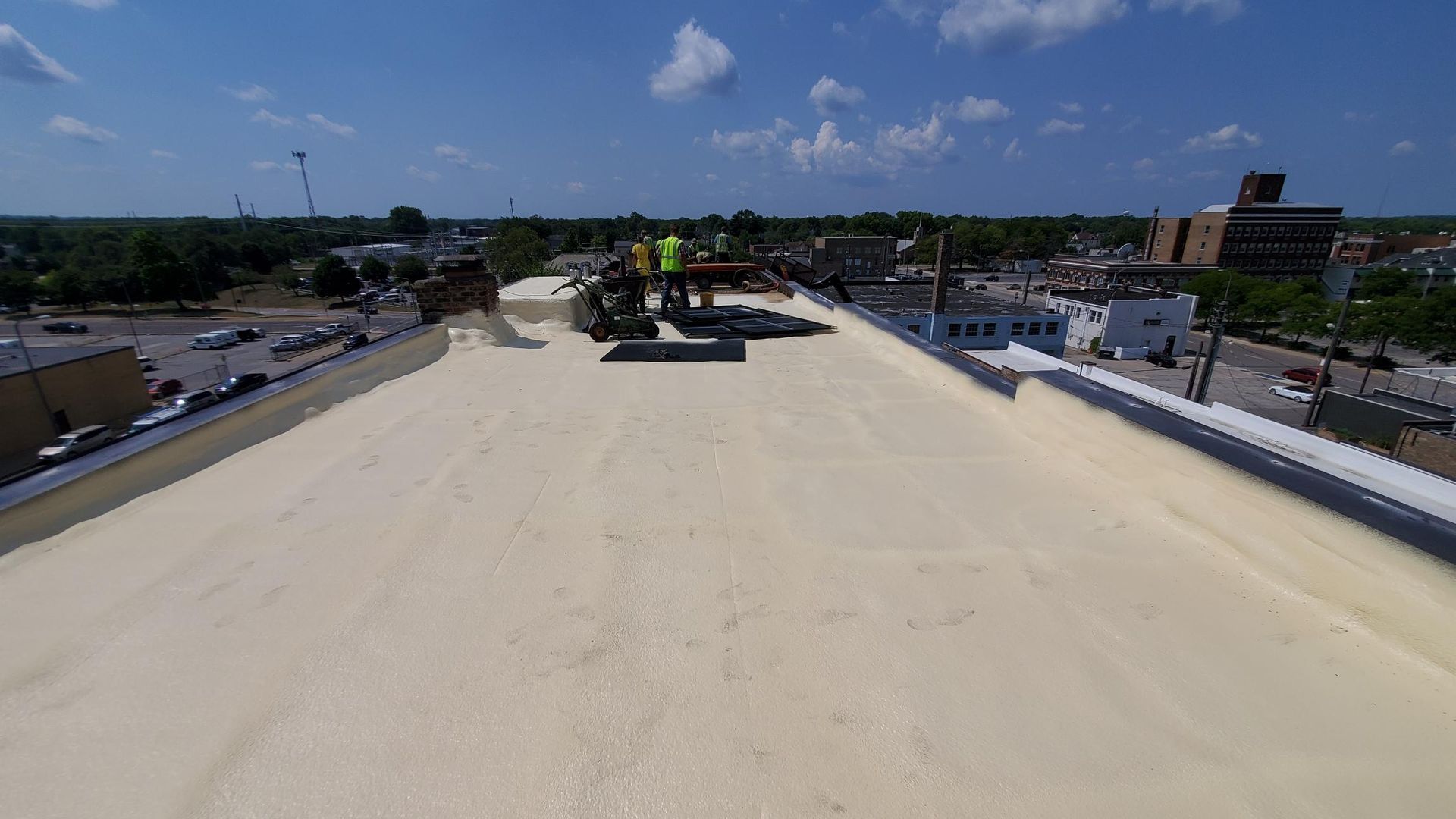A group of people are standing on top of a roof.