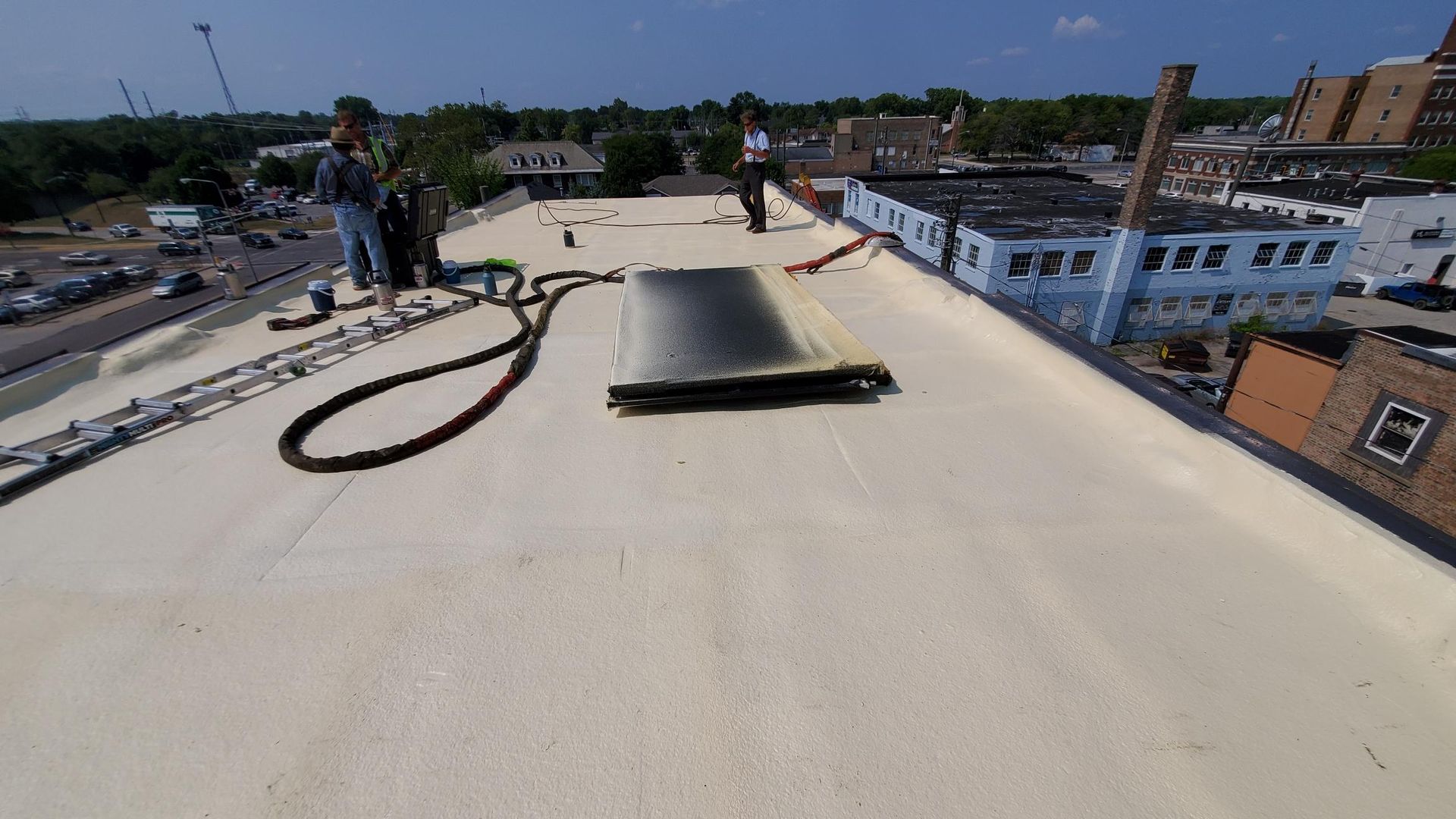 A group of people are standing on top of a roof.