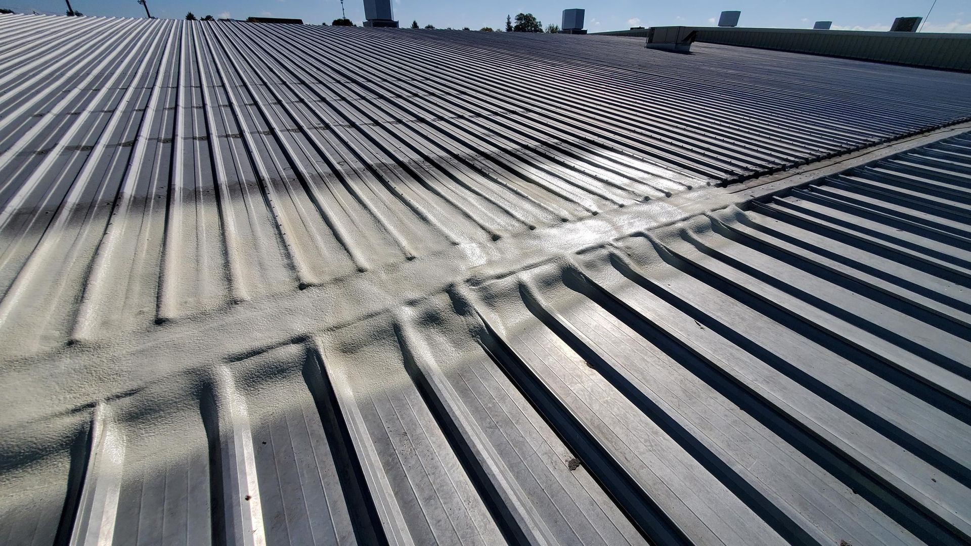 A close up of a metal roof with a lot of lines on it.