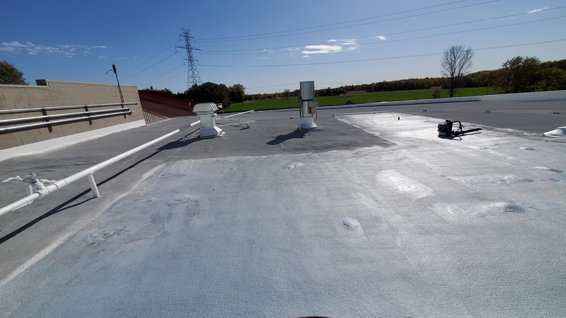 The roof of a building is covered in a white coating.