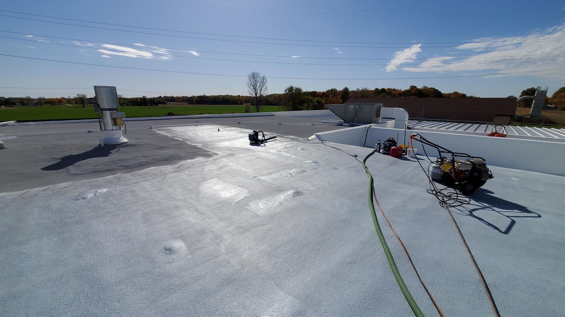A person is working on a roof with a rope.