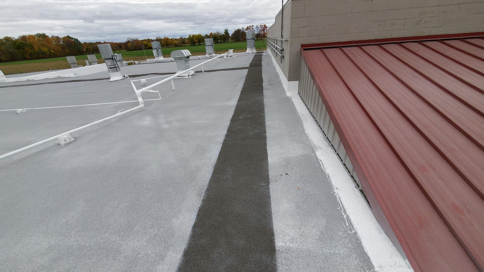 A roof with a red roof and a black line on it.