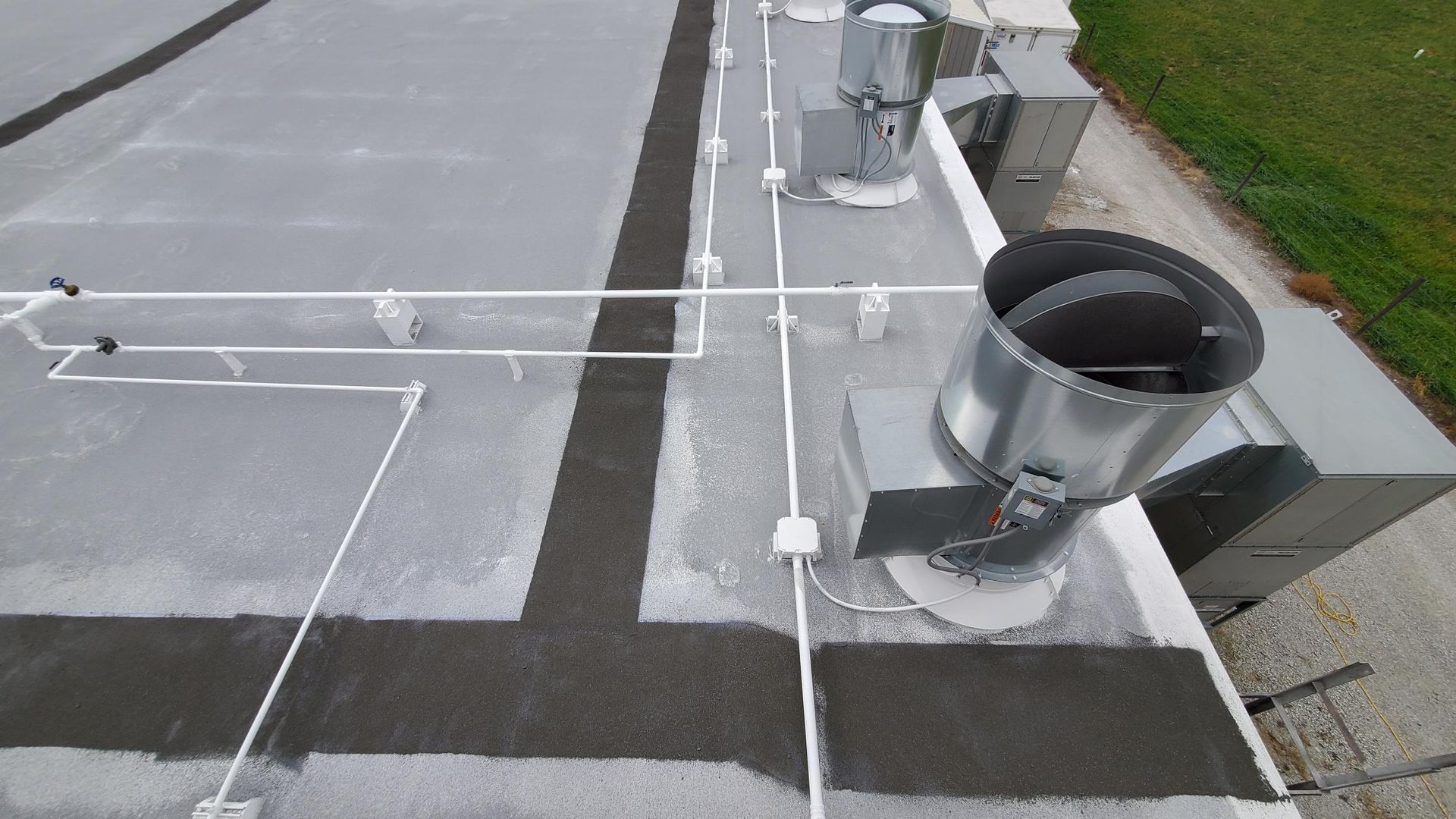 An aerial view of a roof with a lot of pipes on it