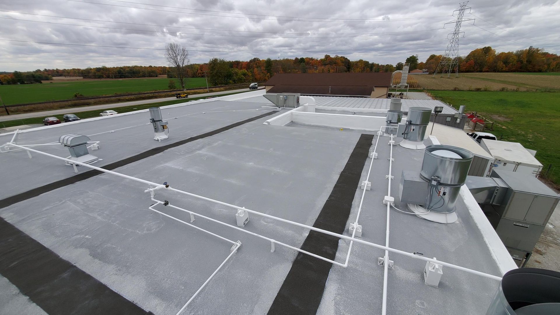 The roof of a building with a lot of pipes on it.
