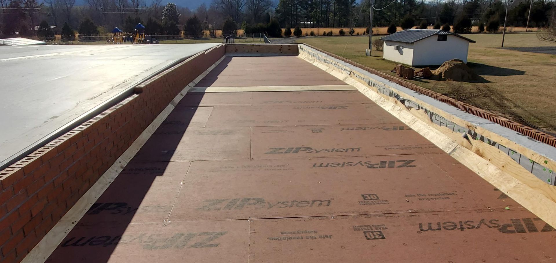 A large piece of wood is sitting on top of a concrete surface.
