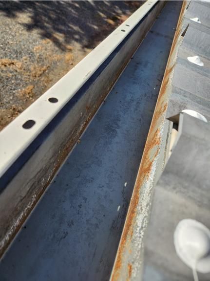 A close up of a metal gutter on a roof