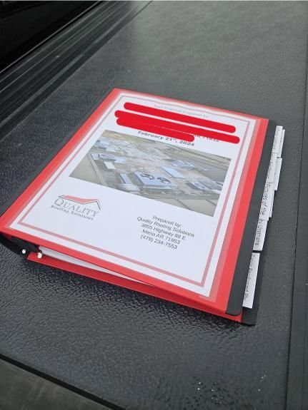 A red binder with a white page that says dash on it