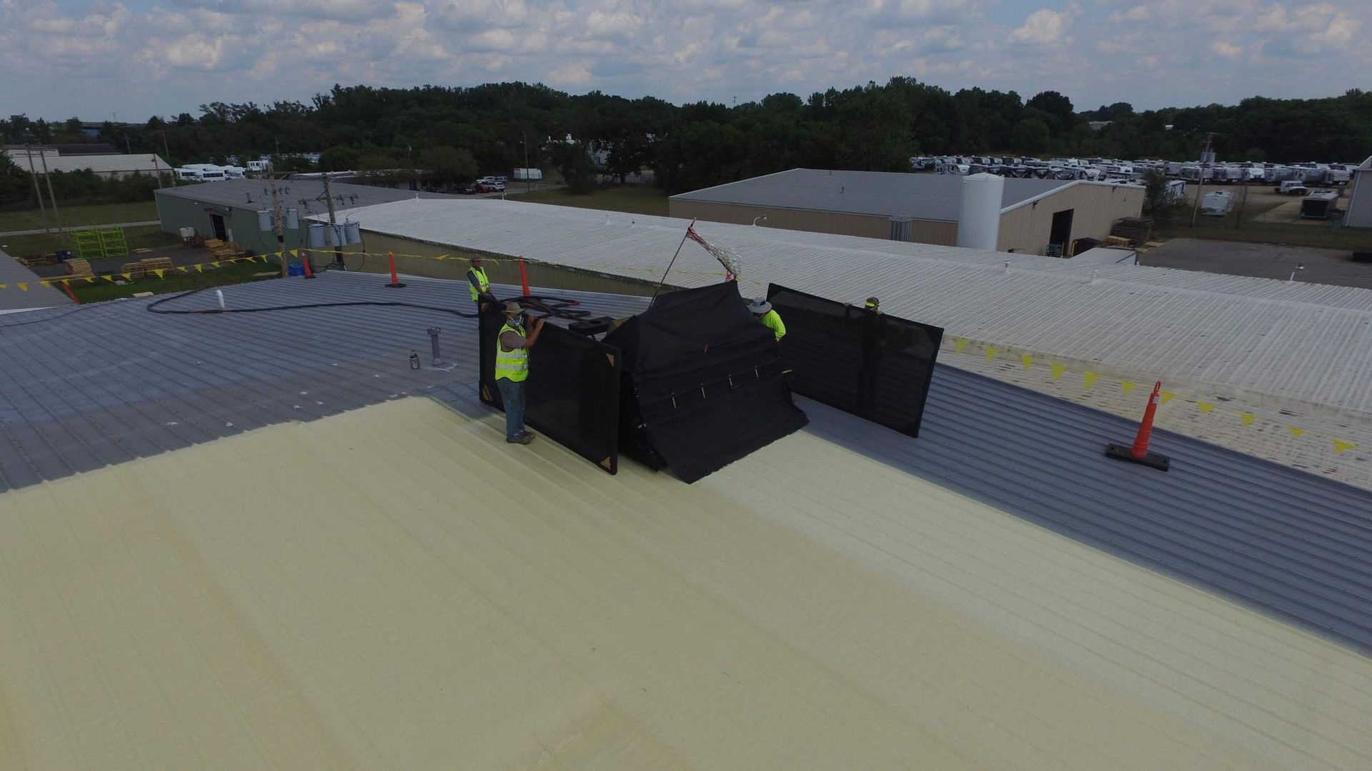 A group of people are working on a roof.