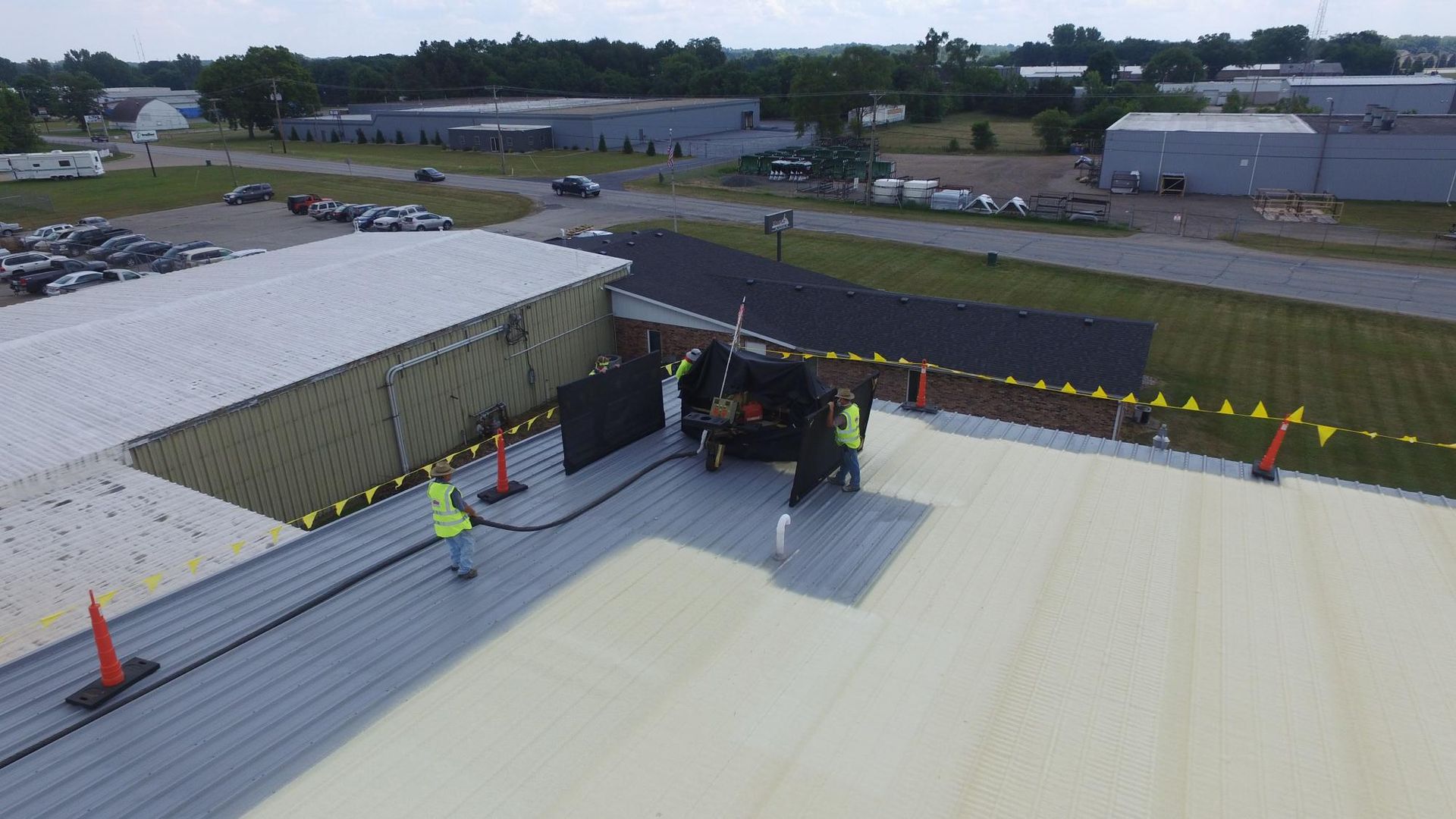 A group of people are working on the roof of a building.