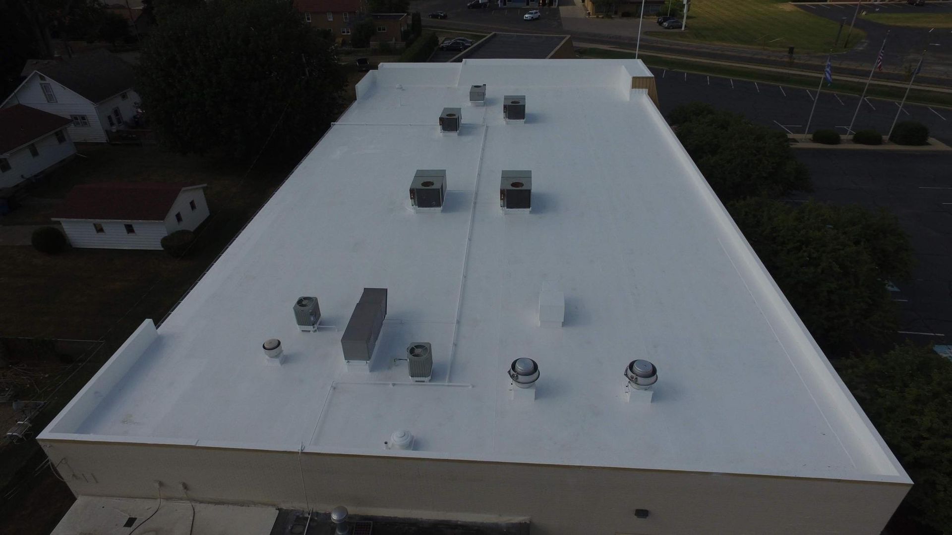 An aerial view of a white roof of a building.