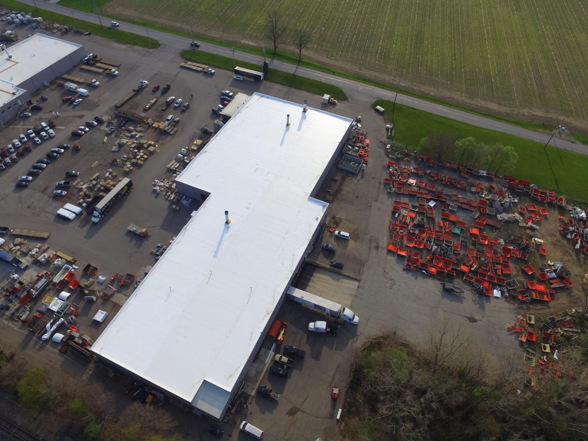 An aerial view of a large building with a white roof