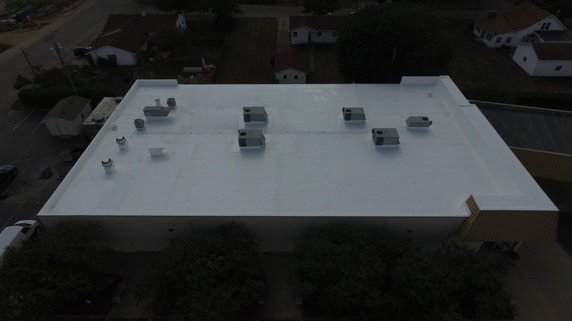 An aerial view of a white roof of a building.