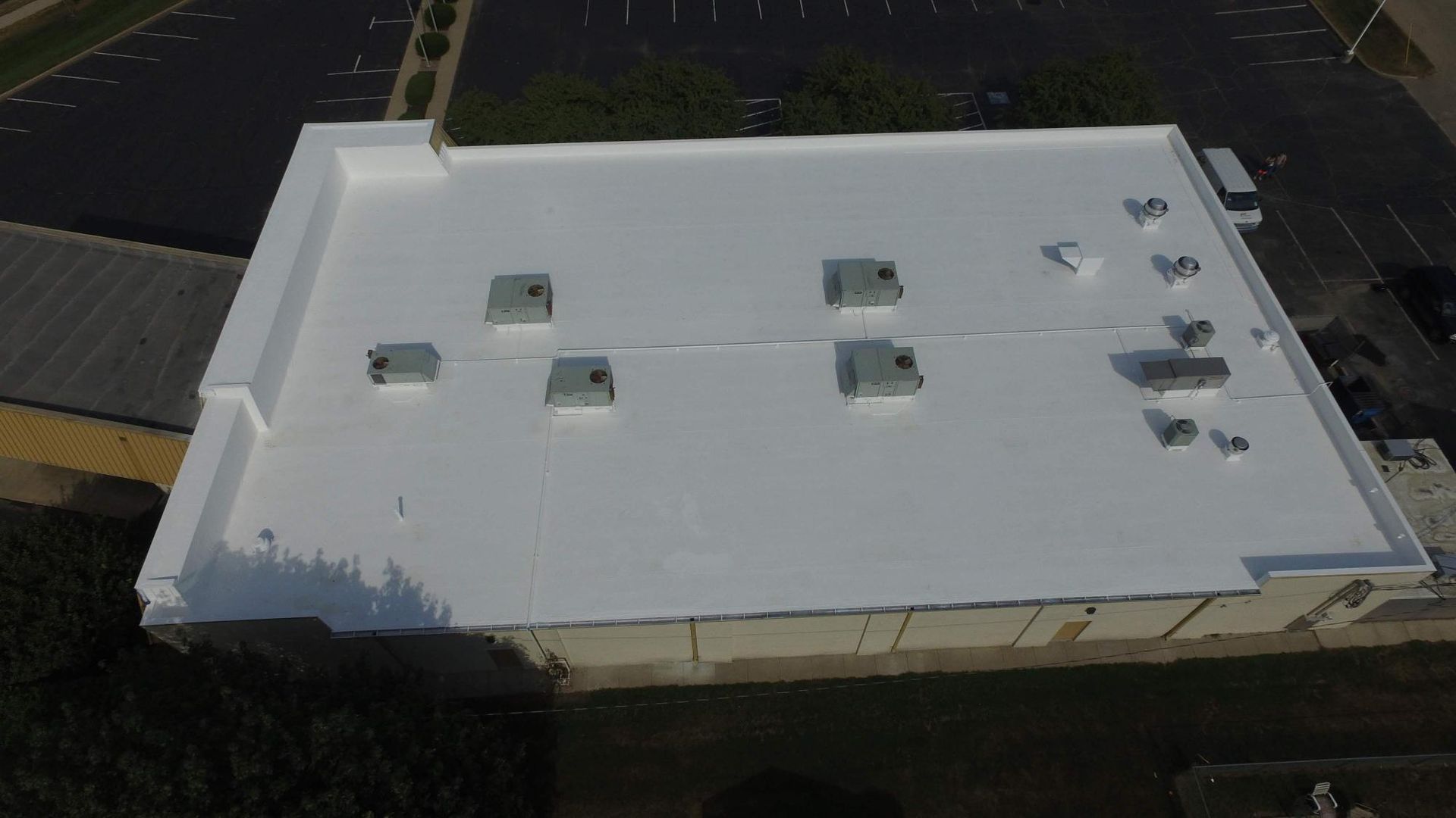 An aerial view of a white roof of a building.