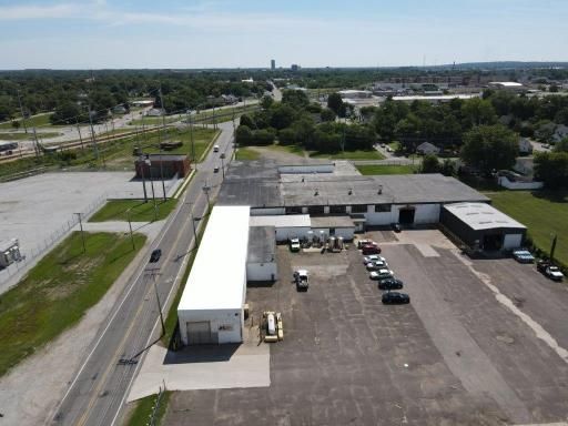 An aerial view of a large building with a white roof