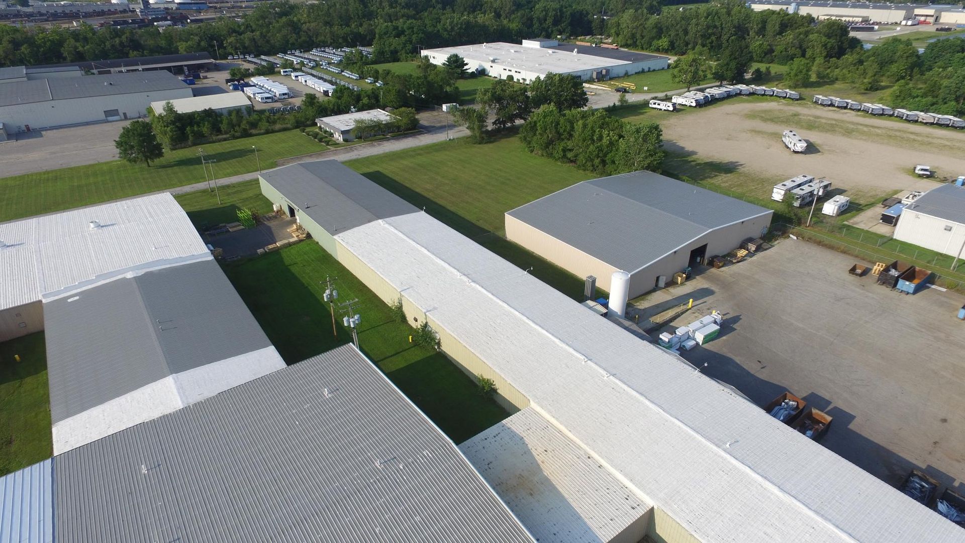 An aerial view of a large industrial area with lots of buildings and trees.