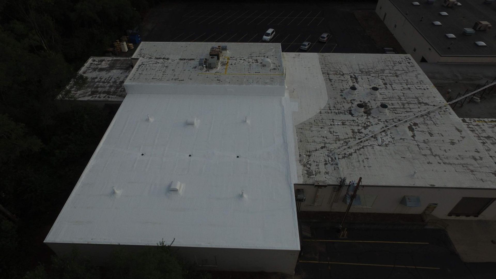 An aerial view of a white roof of a building.