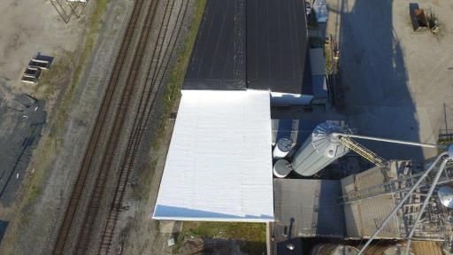 An aerial view of a factory with a white roof.