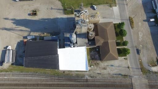 An aerial view of a building with a white roof.