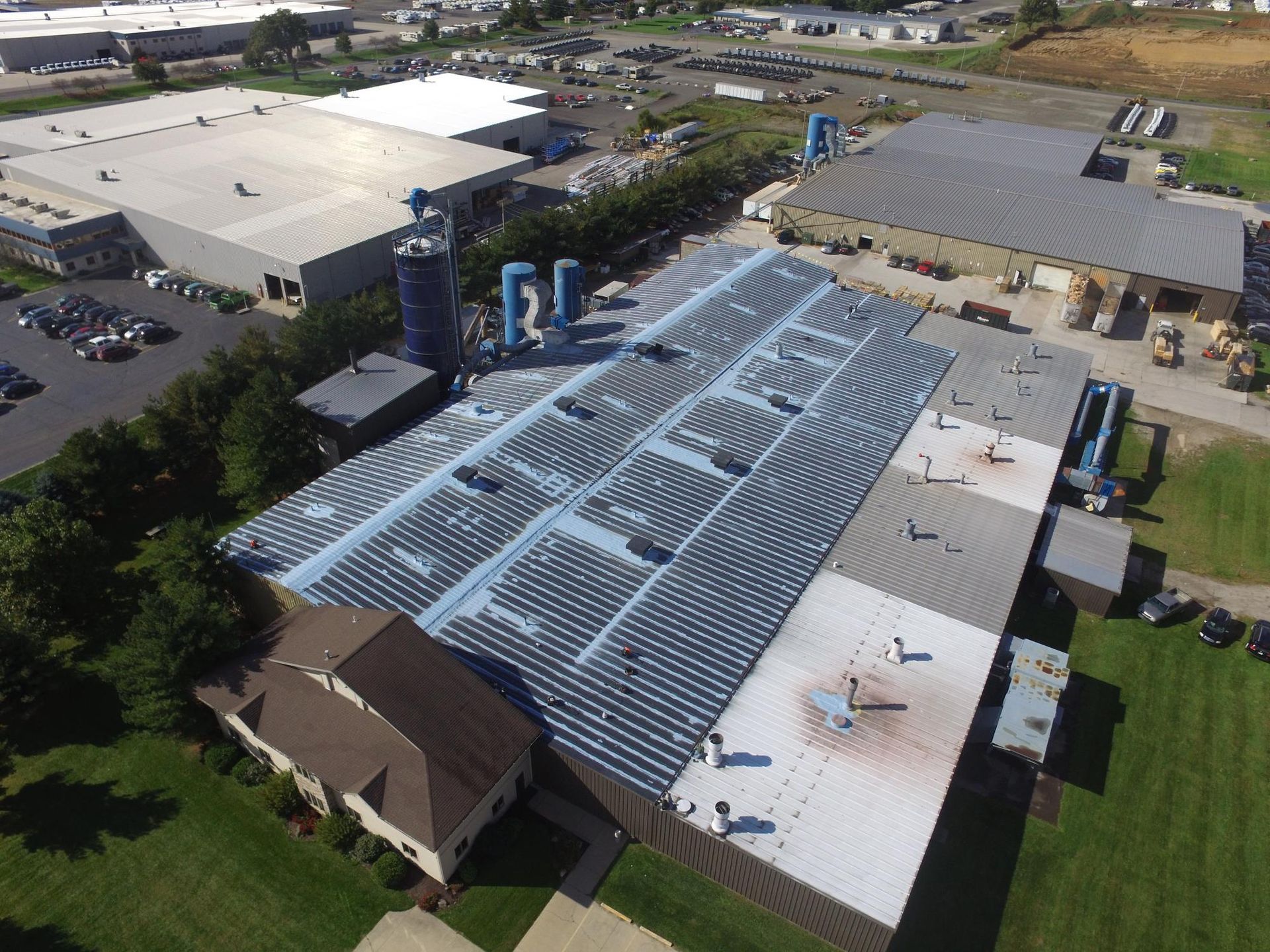 An aerial view of a large building with a solar panel on the roof.