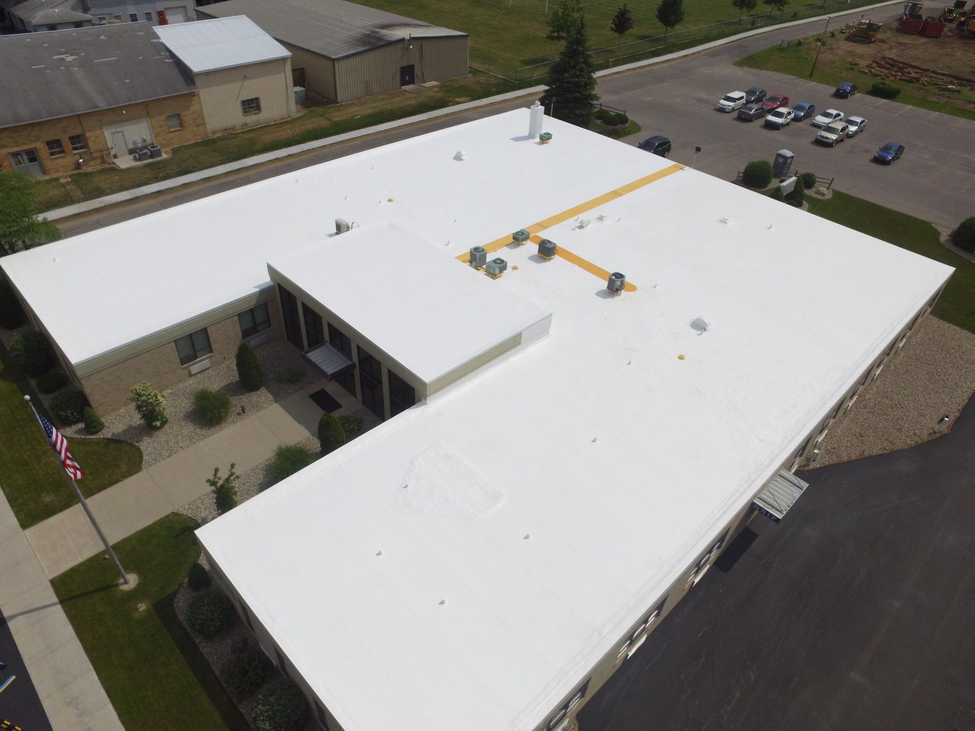 An aerial view of a building with a white roof.