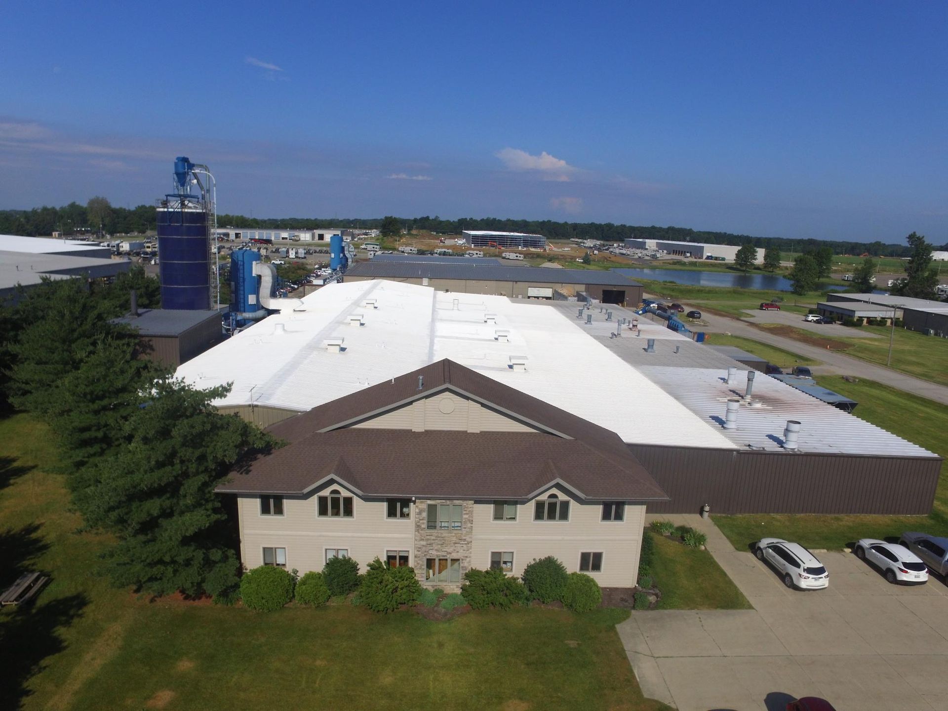 An aerial view of a large building with a white roof