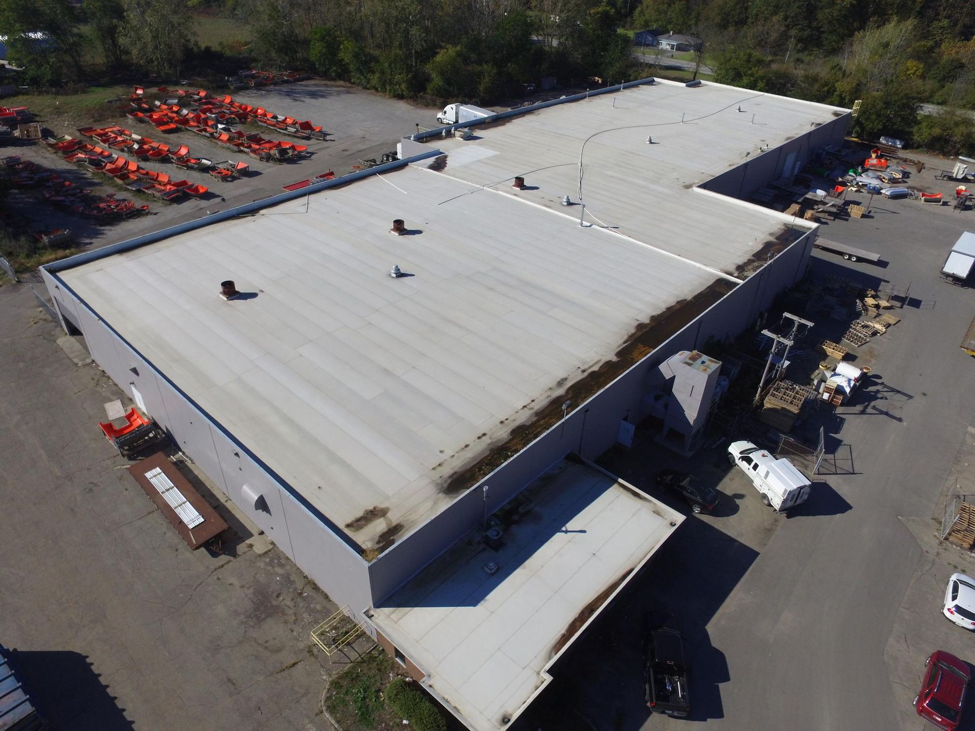 An aerial view of a large building with a white roof.