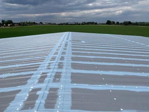 A concrete surface with white tape on it and a field in the background