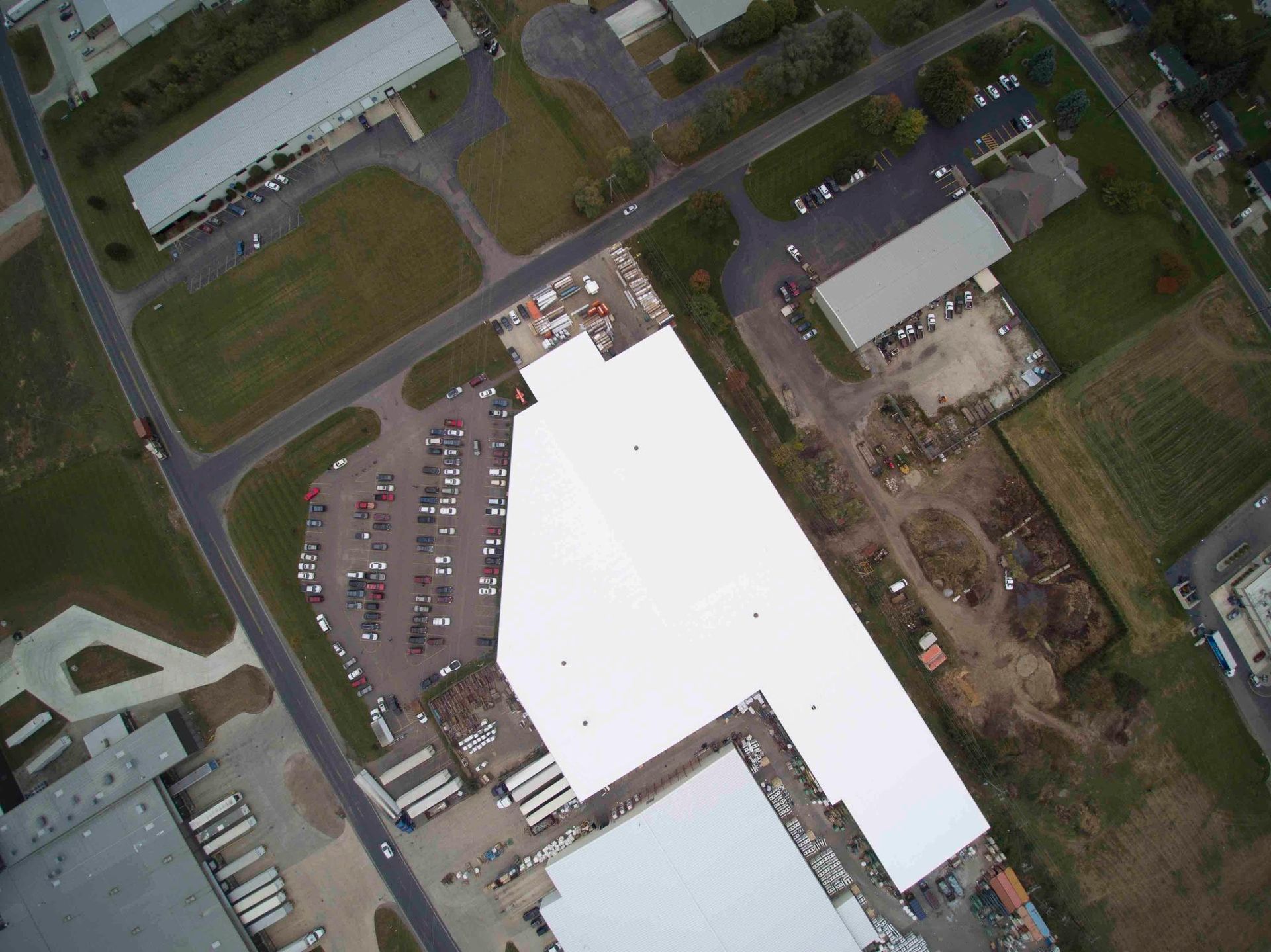 An aerial view of a building with a white roof