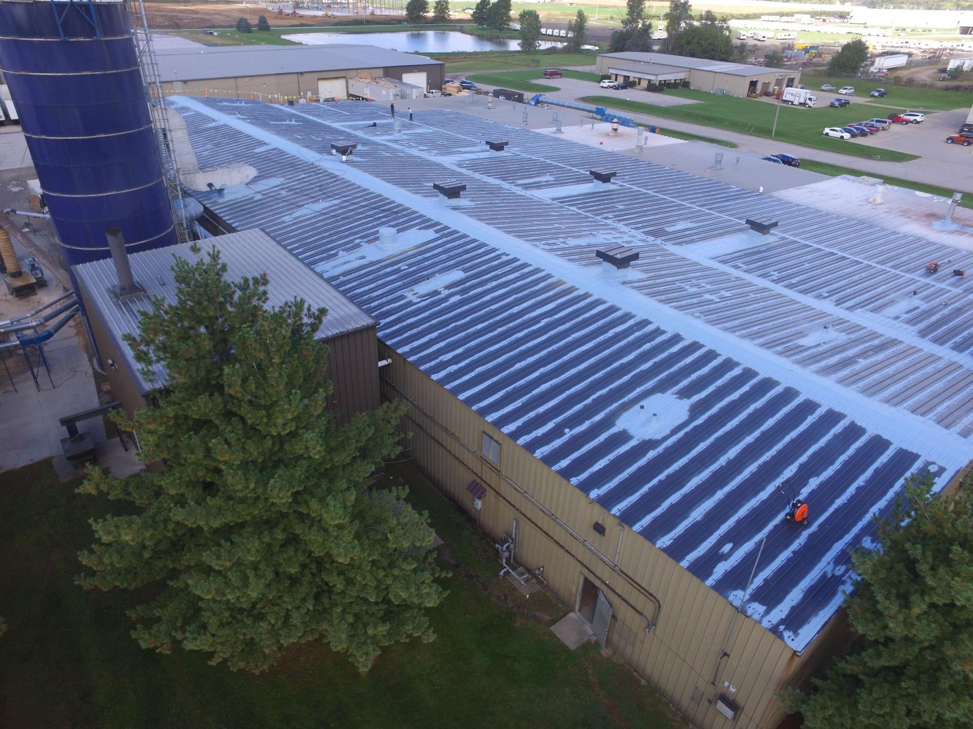 An aerial view of a large building with solar panels on the roof.