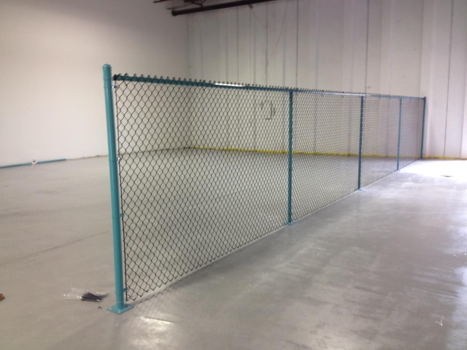 There is a chain link fence in the middle of a room.