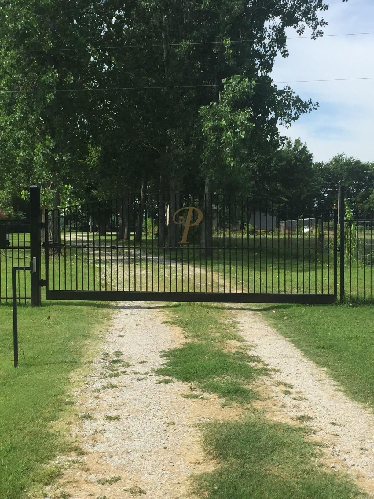 A gate that has the letter p on it