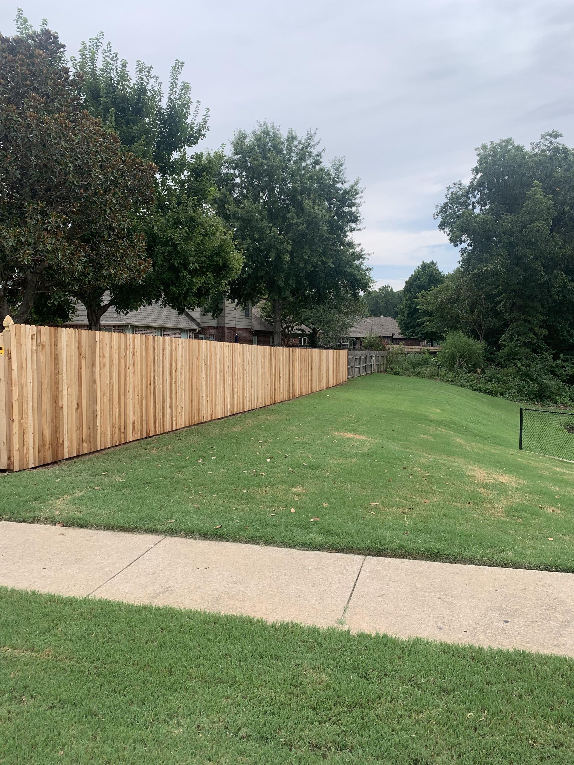 Another view of wooden fence around house