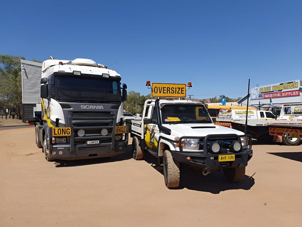 Two Trucks Are Parked Next To Each Other On A Dirt Road — AHT Towing in Ciccone, NT
