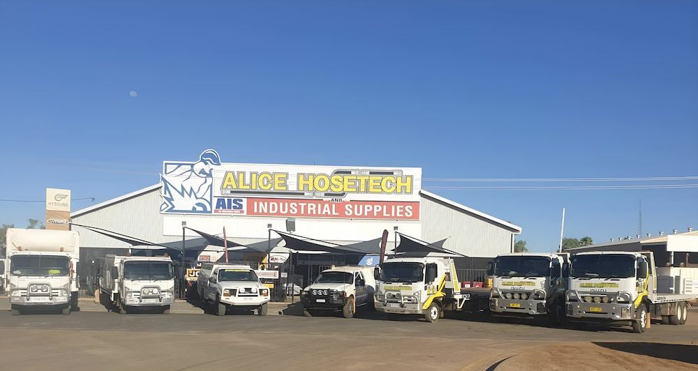 A Group Of Trucks Are Parked In Front Of A Building — AHT Towing in Ciccone, NT