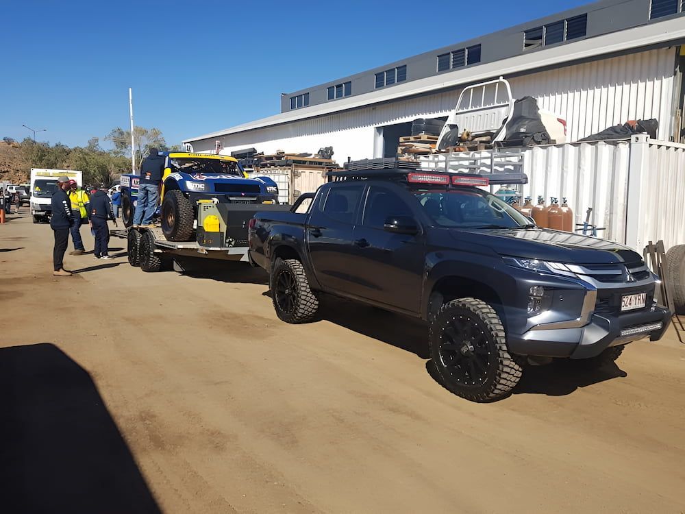 A Pickup Truck Is Being Towed By A Trailer — AHT Towing in Ciccone, NT